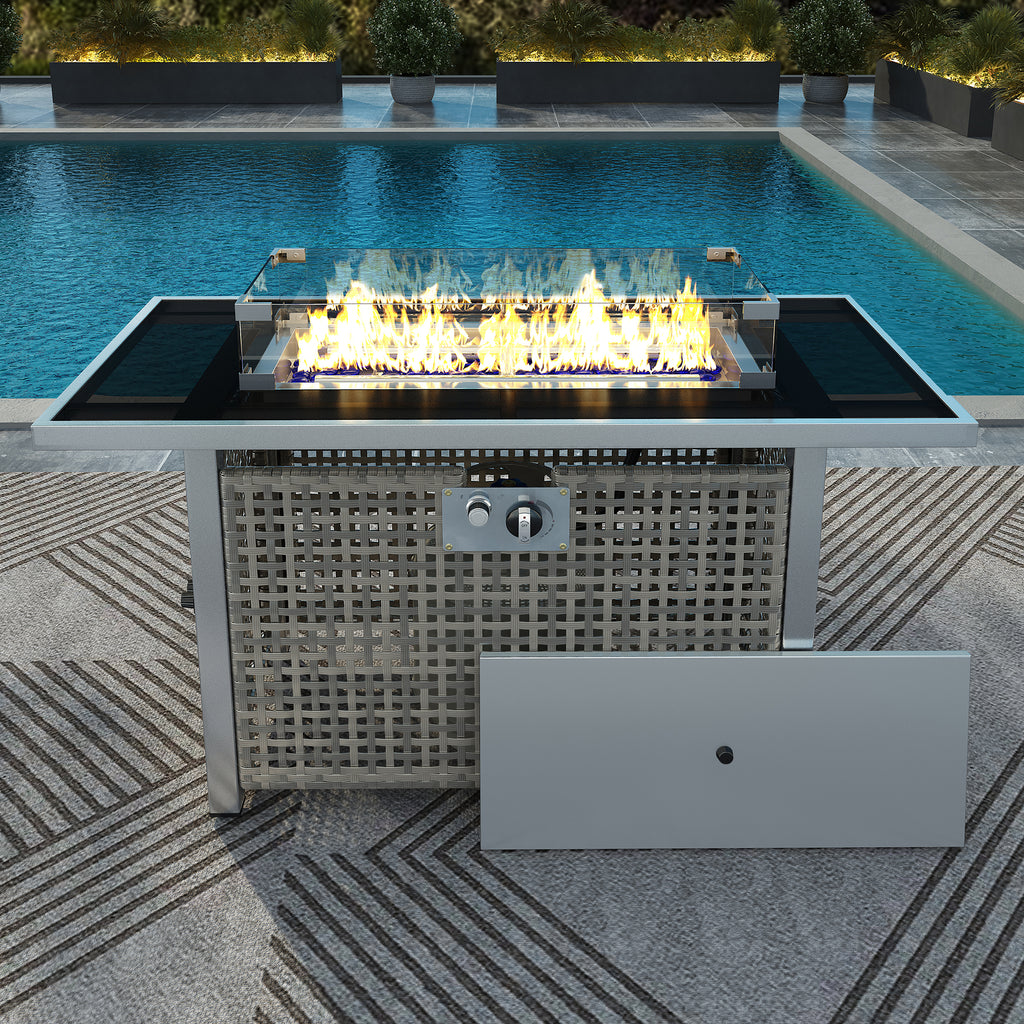 Wicker fire pit table with blue fire glass and flame